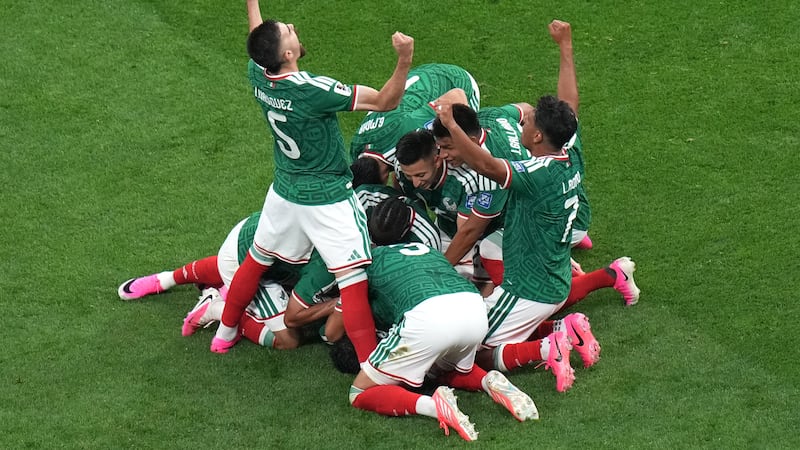 Mexico's Raul Jimenez (9) celebrates with teammates after scoring their second goal during the...