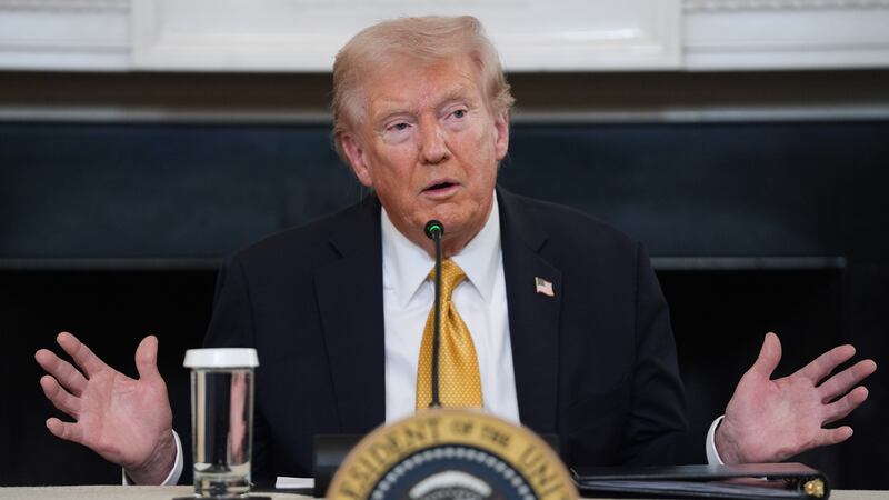 President Donald Trump answers questions from reporters during a roundtable on criminal...